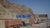 FILE - Trucks carrying containers stand idle at the closed Torkham border crossing between Pakistan and Afghanistan. 