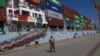 FILE - A Pakistan Navy soldier stands guard while a loaded Chinese ship prepares to depart, at Gwadar port, about 700 kilometers (435 miles) west of Karachi, Pakistan, Nov. 13, 2016.
