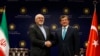 Iranian Foreign Minister Mohammad Javad Zarif (L) shakes hands with his Turkish counterpart Ahmet Davutoglu after a news conference in Ankara November 1, 2013.