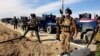 FILE - Iraqi Security forces preparing to attack al-Qaida positions in Ramadi, 70 miles (115 kilometers) west of Baghdad, Iraq. Militants, many from the al-Qaida-breakaway group Islamic State in Iraq and the Levant, overran Fallujah and parts of Anbar’s capital, Ramadi.