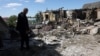 A local resident examines a private house destroyed by a missile attack in the village of Krasylivka, Kyiv region, on May 8, 2024, amid the Russia invasion in Ukraine.