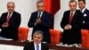 Turkey's President Abdullah Gul (C) is applauded by Prime Minister Tayyip Erdogan (R) and his ministers as he arrives to address the Turkish Parliament during a debate marking the reconvene of the parliament after a summer recess in Ankara, Oct. 1, 2013.