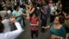 FILE - Elderly people dance on a street during the International Day of Older Persons in Sao Paulo's Avenida Paulista, Brazil, October 2013.