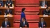 Newly-named Chinese vice Premier Liu Yandong walks past top leaders, including (front row from left to right), National People's Congress chairman Zhang Dejiang and Chinese President Xi Jinping, in Beijing's Great Hall of the People, China, March 16, 2013