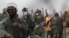 US Border Patrol agents make arrests during a pro-migration protest by members of various faith groups showing support for Central American asylum-seekers who arrived in recent caravans and calling for an end to migrant detentions and deportations, in San Diego as seen through th
