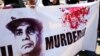 FILE - Supporters of ousted Egyptian President Mohammed Morsi carry a banner against Abdel Fattah el-Sissi during a demonstration in front of the National Council for Human Right building in Cairo. 