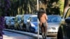 FILE - A prostitute waits for a client in a street of Nice southern France, Nov. 21, 2013. France’s government is pushing one of Europe’s toughest laws against prostitution and sex trafficking, and other countries are watching closely.