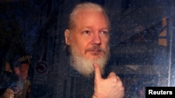 WikiLeaks founder Julian Assange arrives at the Westminster Magistrates Court, after he was arrested in London, April 11, 2019. 