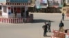 FILE - Afghan policemen keep watch at the downtown of Kunduz city, Afghanistan, Oct. 3, 2016.