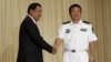Yu Manjiang (R), commander officer of the Chinese fleet, is welcome by Cambodia's Prime Minister Hun Sen in Phnom Penh, Feb. 24, 2016. 