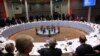 British Prime Minister Theresa May, foreground, walks by as EU leaders sit for a dinner meeting at an EU summit in Brussels, May 28, 2019.