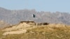 FILE - A Pakistani flag flies on top of a Pakistani check point at the Goshta district of Nangarhar province, where Afghanistan shares a border with Pakistan, May 2, 2013. 