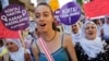Demonstrators shout slogans, march with placards to protest the government's plans on a new abortion law, Istanbul, June 17, 2012.