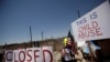 Activists hold a protest against the treatment and conditions of children in immigration detention outside U.S. Customs and Border Protection's Border Patrol station facilities in Clint, Texas
