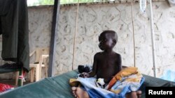 FILE - A South Sudanese child suffering from cholera sits on a bed in Juba Teaching Hospital.