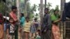FILE - Rohingya refugees from Myanmar are seen outside their makeshift homes near Kutapalong refugee camp in the Cox's Bazar district of Bangladesh, Feb. 9, 2018.