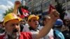 Miners join nearly 2,000 university students, some wearing miners' hard-hats, who called on the government to resign in Ankara, Turkey, May 19, 2014.