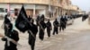 This undated file image posted on a militant website on Tuesday, Jan. 14, 2014 shows fighters from the al-Qaida linked Islamic State of Iraq and the Levant (ISIS) marching in Raqqa, Syria