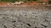 FILE - A devastating drought sweeps across Texas, turning rivers into sand, creeks into mud and lakes into large puddles, The bottom of the pond at the the Gene Howe Wildlife Management Area is nearly dried up in Amarillo, Texas. 