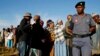 File - A police officer looks on at a voting station during the Lesotho national election in Magkhoakhoeng village outside the capital Maseru, Feb. 28, 2015. 