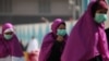 Muslim pilgrims wears surgical masks to help prevent infection from a respiratory virus known as the Middle East Respiratory Syndrome (MERS) in the holy city of Mecca, Saudi Arabia, May 13, 2014.