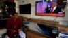 FILE - A salesman in Karachi, Pakistan, eats breakfast as he watches Donald Trump's November 9, 2016 victory speech.