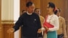 Shwe Mann, left, speaker of Myanmar's Union Parliament, greets National League for Democracy leader Aung San Suu Kyi before their meeting at the Lower House of Parliament, Naypyitaw, Nov. 19, 2015.