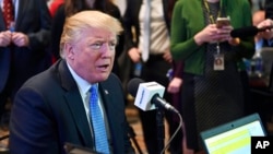 FILE - President Donald Trump sits for a radio interview in the Eisenhower Executive Office Building in the White House complex in Washington, Oct. 17, 2017.