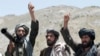 FILE - Taliban fighters react to a speech by their senior leader in the Shindand district of Herat province, Afghanistan. Taliban spokesman Zabihullah Mujahid said the group would be ready for peace talks with the United States, if their demands were met.