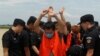 Suspected of telecom fraud are escorted by Chinese police SWAT team