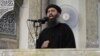 FILE - This image from video posted in July purports to show Islamic State leader Abu Bakr al-Baghdadi delivering a sermon in Iraq.