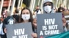Activists display placards during a rally at the AIDS Conference 2014 at the Melbourne Convention and Exhibition Centre (MCEC) in Melbourne, on July 22, 2014. 