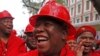 FILE - Julius Malema, center, leader of the Economic Freedom Fighters (EFF), arrives at Parliament wearing a hard hat and overall to show solidarity with coal mine workers, in Cape Town, South Africa, May 21, 2014.