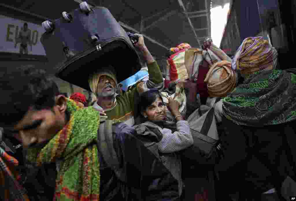 Indians crowd on a train on platform six near where a stampede took pace a night before, at a station in Allahabad, India, Feb. 11, 2013.