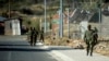 Soldiers walks inside the Makoanyane Barracks in Maseru, Leotho, Sep. 1, 2014.