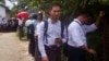 Swe Win, second right, an editor of the nonprofit online news outlet Myanmar Now, waits with other journalists for trial of The Voice editor Kyaw Min Swe outside a township court in Yangon, Myanmar, June 23, 2017.