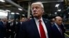FILE - President Donald Trump pauses as he talks to media before signing an Executive Order on the Establishment of Office of Trade and Manufacturing Policy at The AMES Companies, Inc., in Harrisburg, Pa.
