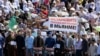 RuChechens hold a banner reading "Stop genocide of Muslims in Myanmar" during a mass protest in Chechnya's provincial capital Grozny, Sept. 4, 2017. 