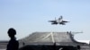 FILE - In this undated photo released on Dec. 31. 2021, by Xinhua News Agency, a carrier-based J-15 fighter jet takes off from the Chinese Navy's Liaoning aircraft carrier. The Chinese navy wants to hire graduate students to fly shipborne aircraft.