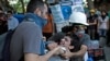 A protester affected by tear gas is helped by other protesters to a field hospital in Gezi Park in Taksim square in Istanbul, June 11, 2013. 