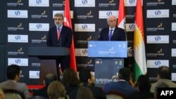 Turkish Energy Minister Taner Yildiz (L) and his Iraqi Kurdish counterpart Ashti Hawrami hold a press conference in Arbil, the capital of the autonomous Kurdish region in northern Iraq, Dec. 2, 2013. 