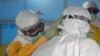 A U.S. doctor in a protective suit in Liberia adjust that of a colleague before entering an Ebola treatment unit in Monrovia in this photo released Sept. 16, 2014.