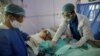 Medical workers attend to a COVID-19 patient in an intensive care unit at a hospital in Sanaa, Yemen, June 14, 2020.