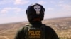 A U.S. Border Patrol agent, wearing a helmet while riding an ATV, searches for migrants trying to enter the United States from the Mexico border in a desert area in Sunland Park, New Mexico, on Aug. 17, 2023.