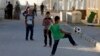 Syrian refugee children play with a soccer ball at the Mrajeeb Al Fhood refugee camp in Zarqa, Jordan, July 1, 2014.