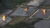 FILE - A gas flare at Shell Cawtharine Channel, Nembe Creek in the Niger Delta. 