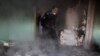 An Afghan police officer inspects the house of an Afghan member of parliament which was attacked by Taliban last night in Kabul, Afghanistan, Dec. 22, 2016. 