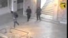 FILE - In this frame made from CCTV and released by the Tunisian government, two gunmen and third unidentified man can be seen inside the Bardo museum in Tunis, March 18, 2015. 