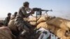 FILE - A Yemeni fighter backed by the Saudi-led coalition fires his weapon during clashes with Houthi rebels on the Kassara frontline near Marib, Yemen, June 20, 2021. 