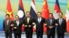 (L-R) Vietnamese Foreign Minister Pham Binh Minh, Prime Ministers Thongsing Thammavong of Laos, Prayuth Chan-ocha of Thailand, Li Keqiang of China, Hun Sen of Cambodia and Myanmar's Vice President Sai Mauk Kham pose for pictures during their meeting in Sanya, Hainan province, China, March 23, 2016.